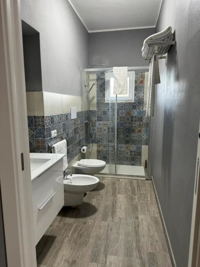 Bagno con doccia, bidet e piastrelle decorate